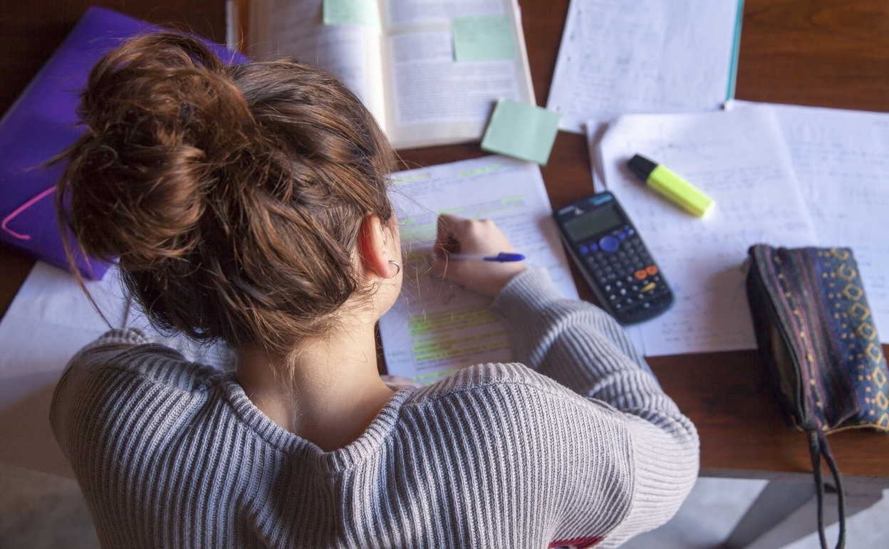 10 Tips To Help You Win A Private Scholarship young woman seated at a desk working on applications