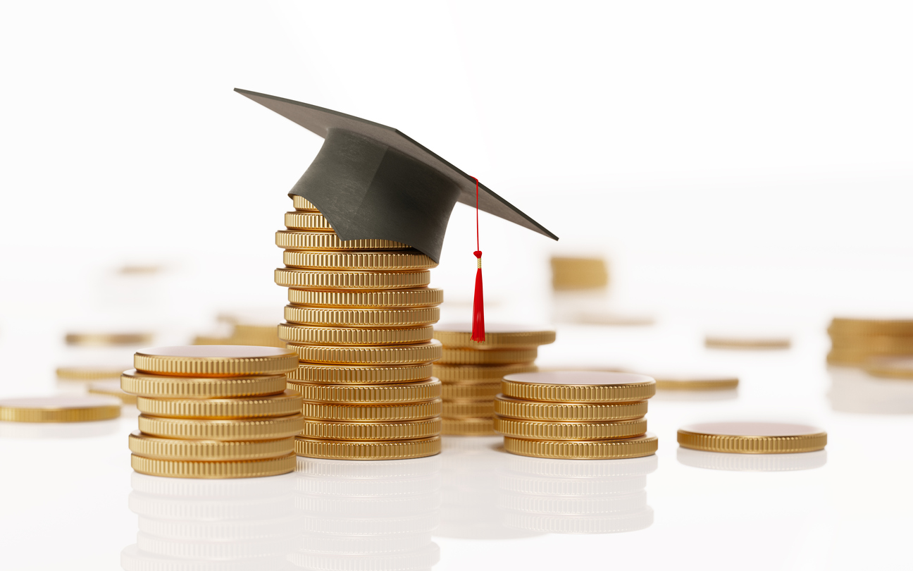 How to Compare Financial Aid and Make That Final College Decision Mortar board on pile of coins meant to pay for college.