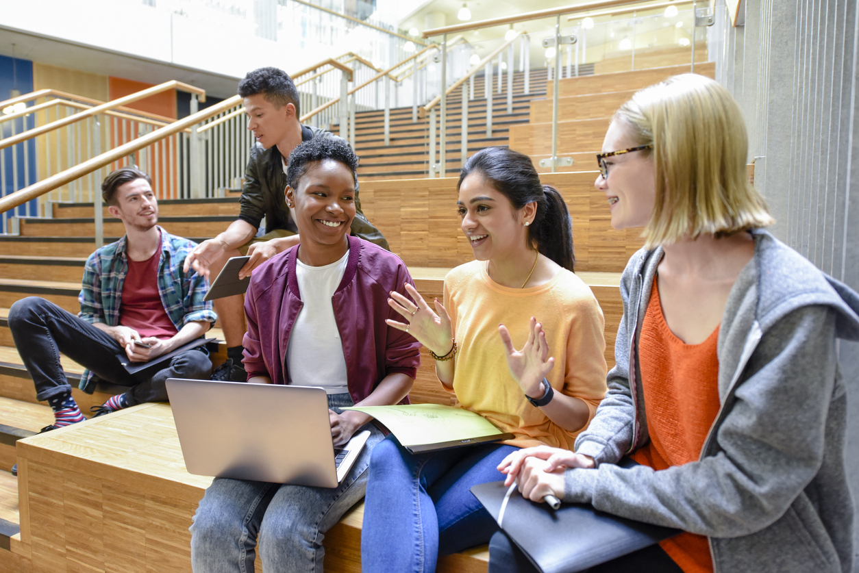 How to Put Together a College List That Finds the Perfect Fit Diverse group of college students with laptops.